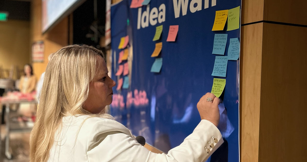 Kiersten Hafer adding ideas to the idea wall