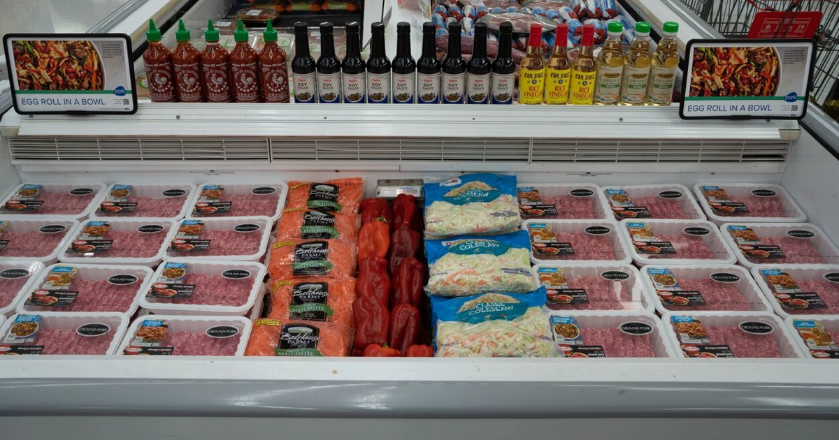 Ground pork in the meatcase displaying the ingredients for egg roll in a bowl